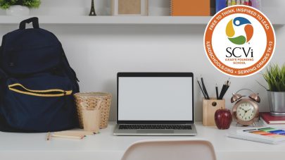 desk, laptop, backpack, SCVi Charter School logo