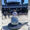 Santa Clarita Valley International (SCVi) school teacher Justin Albright wears a Dodgers hat and baseball cap in front of Dodger Stadium and leans on a LA Champions sculpture that reads ‘2020 World Series Champions’ at the bottom.